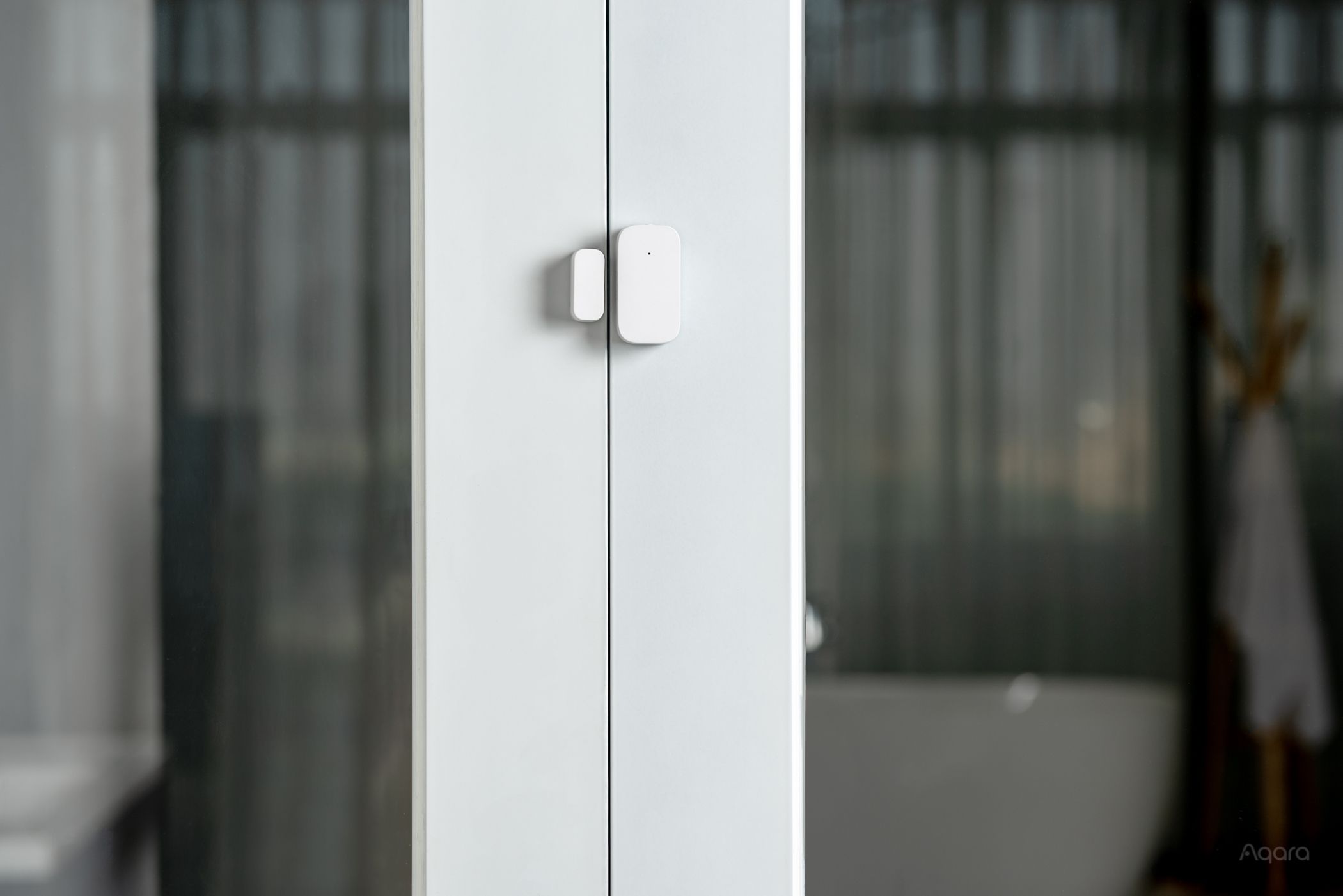 The Aqara Door and Window Sensor installed on a close door